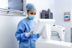 female-surgeon-with-surgical-mask-operating-room-using-3d-image-guided-surgery-machine